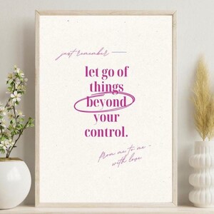 May include: A framed print with the words "let go of things beyond your control" in purple script. The print has a light beige background and is surrounded by a wooden frame. The text is accompanied by the phrase "just remember" and "from me to me - with love".