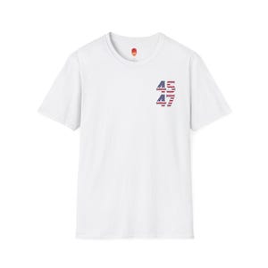 May include: White t-shirt with a graphic of the numbers 45 and 47, each number is made up of the American flag.
