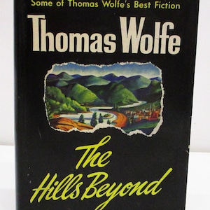 May include: A black book cover with the title "The Hills Beyond" by Thomas Wolfe. The cover features a landscape painting of green hills and a river.