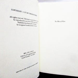 May include: Open book pages with text. The left page reads "COPYRIGHT &copy; 1975 BY THOMAS HARRIS" and other copyright information. The right page is dedicated "To Mary Ellen". The book is printed in the United States of America.