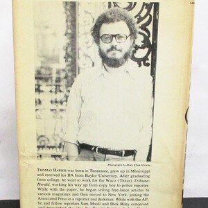 May include: Aged book cover with a portrait of Thomas Harris, author of Black Sunday. The cover includes biographical text about Harris's life and career. The image has a vintage aesthetic, with a photograph of Harris.