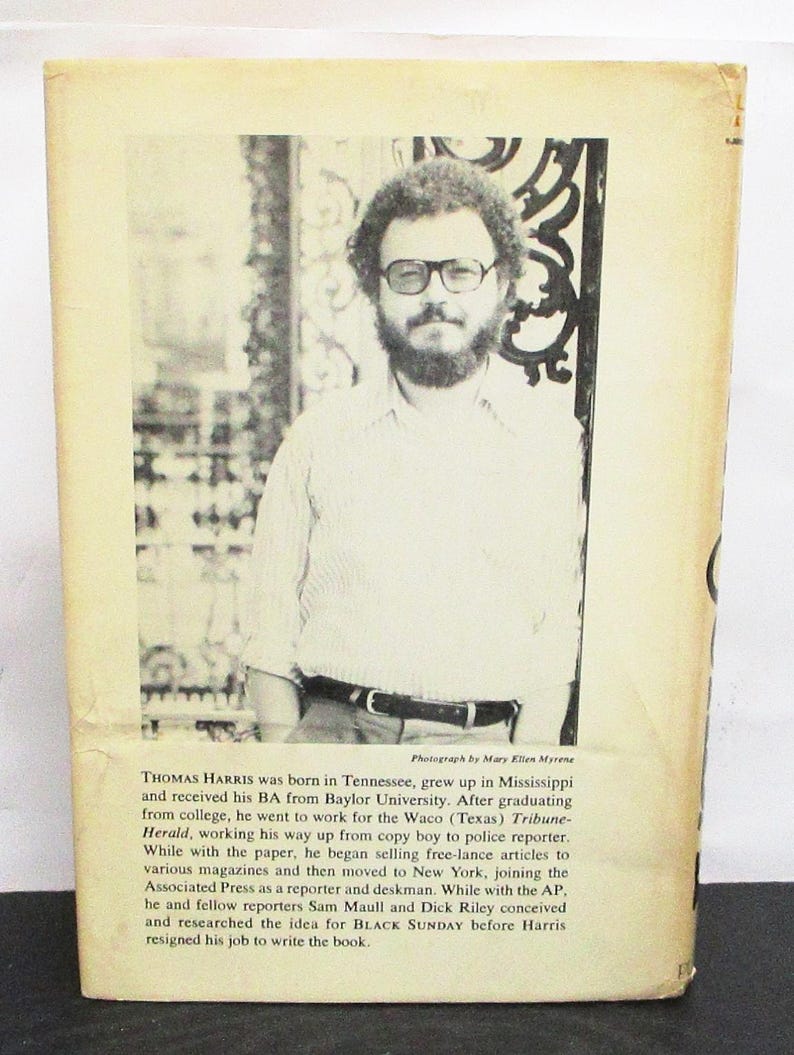 May include: Aged book cover with a portrait of Thomas Harris, author of Black Sunday. The cover includes biographical text about Harris's life and career. The image has a vintage aesthetic, with a photograph of Harris.