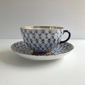 Vintage Imperial Lomonosov porcelain cobalt blue net teacup and saucer set gilded with 22k gold, marked USSR