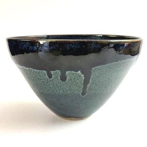 Vintage handmade studio pottery bowl with blue drip glaze