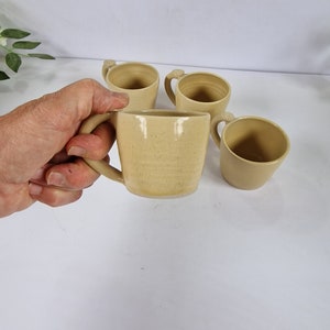 small rustic feel coffee cup, caramel coloured stoneware espresso cup with thumb rest,  small pastel yellow ceramic coffee cup