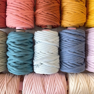 May include: A collection of ten spools of cotton rope in various colours, including sage green, teal, light blue, denim blue, lavender, blush pink, cream, and terracotta.