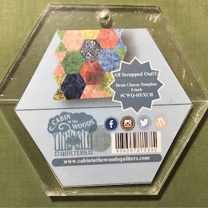 May include: A clear, hexagonal acrylic template for quilting. The template features a colorful patchwork design and text that reads "All Scrapped Out!" and "Hexie Charm Template 5-inch". The template also includes social media icons and the website address.