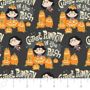 May include: A repeating pattern featuring orange pumpkins, Wonder Woman characters, and the text "Cutest Pumpkin in the Patch" on a dark gray background. The pumpkins have carved faces, and Wonder Woman is depicted in various poses.
