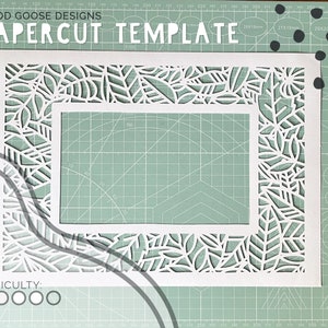 May include: A white paper template with a leafy design cut out around the edges. The template is on a green cutting mat with black dots. The text "GOOD GOOSE DESIGNS" and "PAPERCUT TEMPLATE" is at the top of the image. The text "DIFFICULTY: ○○○○○" is at the bottom of the image.