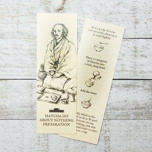 May include: A bookmark featuring a hand-drawn illustration of someone making matcha tea. The bookmark provides instructions for preparing matcha tea, including boiling water, adding matcha powder to a bowl, and whisking the matcha until it forms a froth. The text on the bookmark reads "Matcha Do About Nothing Preparation."