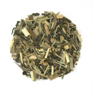May include: A close-up of a blend of green tea, lemongrass, and ginger. The tea is loose leaf and appears to be ready for brewing.