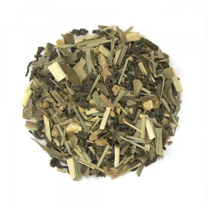 May include: A close-up of a blend of green tea, lemongrass, and ginger. The tea is loose leaf and appears to be ready for brewing.