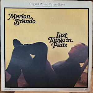 May include: Album cover for "Last Tango in Paris" featuring Marlon Brando. The cover has a sepia tone with the title in stylized lettering. The text "Original Motion Picture Score" is at the top. The album is an Alberto Grimaldi production.