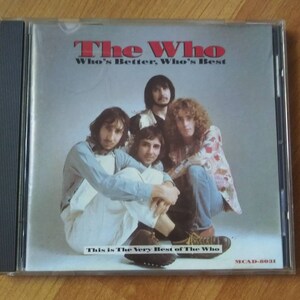 May include: A CD case with a photo of the band The Who. The title of the album is "Who's Better, Who's Best" and the text "This is The Very Best of The Who" is printed below the photo. The album number MCAD-8031 is printed in the bottom right corner.