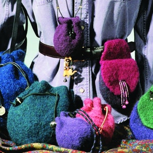 May include: A collection of six colorful knitted drawstring bags in various shades of blue, green, purple, and pink. The bags are made with a fuzzy yarn and have leather drawstrings.
