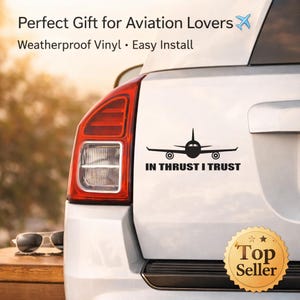 May include: Black vinyl car decal featuring an airplane silhouette with the text "IN THRUST I TRUST." The decal is applied to a white car, with a "Top Seller" sticker visible. The image also includes the text "Perfect Gift for Aviation Lovers."