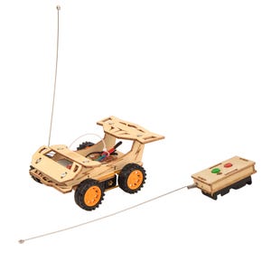 May include: A wooden toy race car with an orange and black design. The car has a remote control with two buttons. The car is connected to the remote control by a wire.