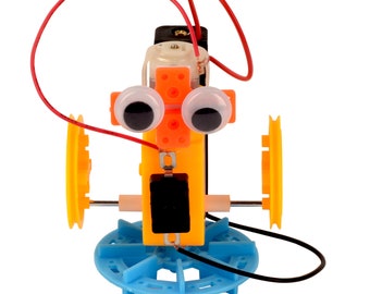 May include: A toy robot with orange and yellow plastic body parts, black eyes, and red and black wires. The robot has two blue wheels and a battery pack.
