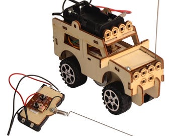 May include: A wooden DIY remote control off-road vehicle kit. The vehicle has black wheels, a battery compartment, and a light bar. The remote control has a circuit board and antenna. The kit is made of unfinished wood.