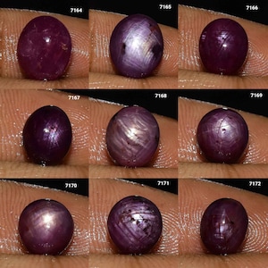 以下が含まれることがあります： 星のような効果を持つ、9つの楕円形の濃い赤色の宝石。各宝石は異なる赤色で、内部パターンが見えます。宝石は暗い背景に表示され、7164から7172までの番号が表示されています。