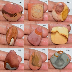 May include: Assortment of ten natural stone cabochons in various shapes and sizes. The stones feature a mix of brown, red, orange, and white colours with unique patterns.