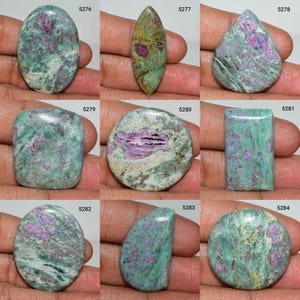 May include: A collection of nine polished gemstones, each with a unique shape. The stones feature a mix of colors, including green, pink, and white, with varying patterns and textures. The gemstones are numbered 5276 through 5284.