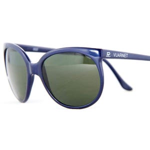 May include: A pair of navy blue sunglasses with dark green lenses. The sunglasses have a rounded frame and the brand name "VUARNET" is printed on the temple. The sunglasses are set against a white background.