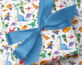 May include: A gift wrapped in paper with a dinosaur pattern, tied with a blue satin bow. The paper has a white background with colourful illustrations of dinosaurs, eggs, and palm trees. Dinosaurs are in blue, green, orange, and purple.