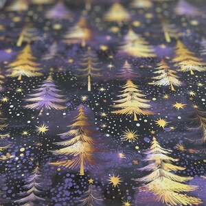 May include: A dark purple and gold wrapping paper with a repeating pattern of stylized gold trees and stars. The background is a dark purple with a subtle shimmer.