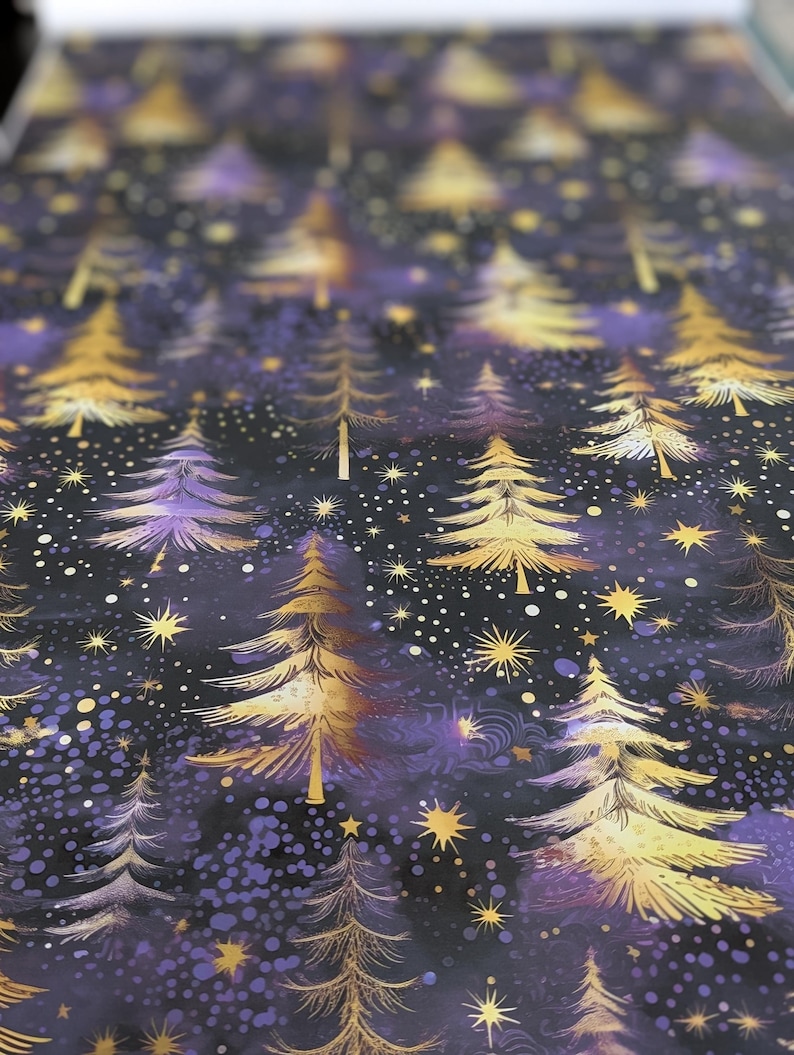 May include: A dark purple and gold wrapping paper with a repeating pattern of stylized gold trees and stars. The background is a dark purple with a subtle shimmer.