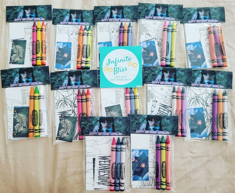 May include: A set of 10 party favor bags with coloring pages and crayons. Each bag features a character from the Addams Family, Wednesday Addams, and the text "Happy Birthday,  " with a name. The bags are decorated with a black and white illustration of the character and the text "Happy Birthday,  " with a name. The crayons are Crayola brand and are in a variety of colors.