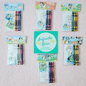 May include: A set of six Bluey-themed coloring packs, each containing a coloring page, stickers, and four crayons. The packs feature different characters from the show, including Bluey, Bingo, and Bandit. The crayons are Crayola brand and are in the colors blue, green, orange, and purple. The packs are packaged in clear plastic bags with a header card that says "Bluey's Shop". The header card also features a logo with the words "Infinite Bliss" and "Gift and Souvenir Shop".