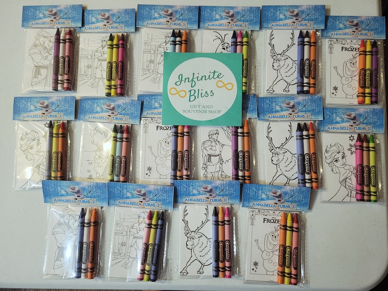 May include: A set of 12 Frozen-themed coloring pages with crayons. Each page features a different character or scene from the movie, such as Elsa, Anna, Olaf, and Sven. The pages are packaged in individual cellophane bags with a header that says "Annabella Turns 31".
