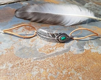 Green beaded feather, cord bracelet.