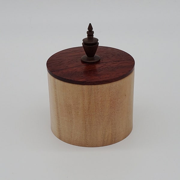 A beautiful lidded box with a maple base, a padauk lid and a walnut finial