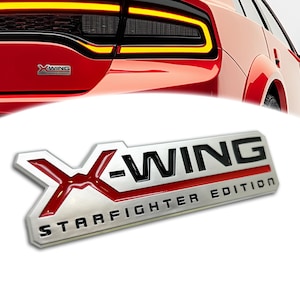 May include: A silver and red metal emblem with the text "X-WING STARFIGHTER EDITION".