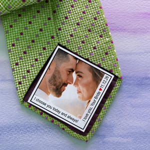 May include: A green tie with a white and purple polka dot pattern. A photo of a couple is attached to the tie with the text "I love you, Your Bride 11.12.26" and "I choose you today and always!"