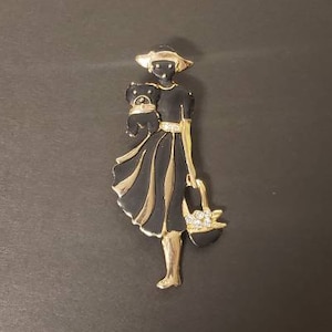1980s Matte Black and Gold Tone Lady with Purse and Dog Rhinestone Brooch