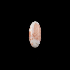 May include: A white and pink oval cabochon gemstone with a swirling pattern.