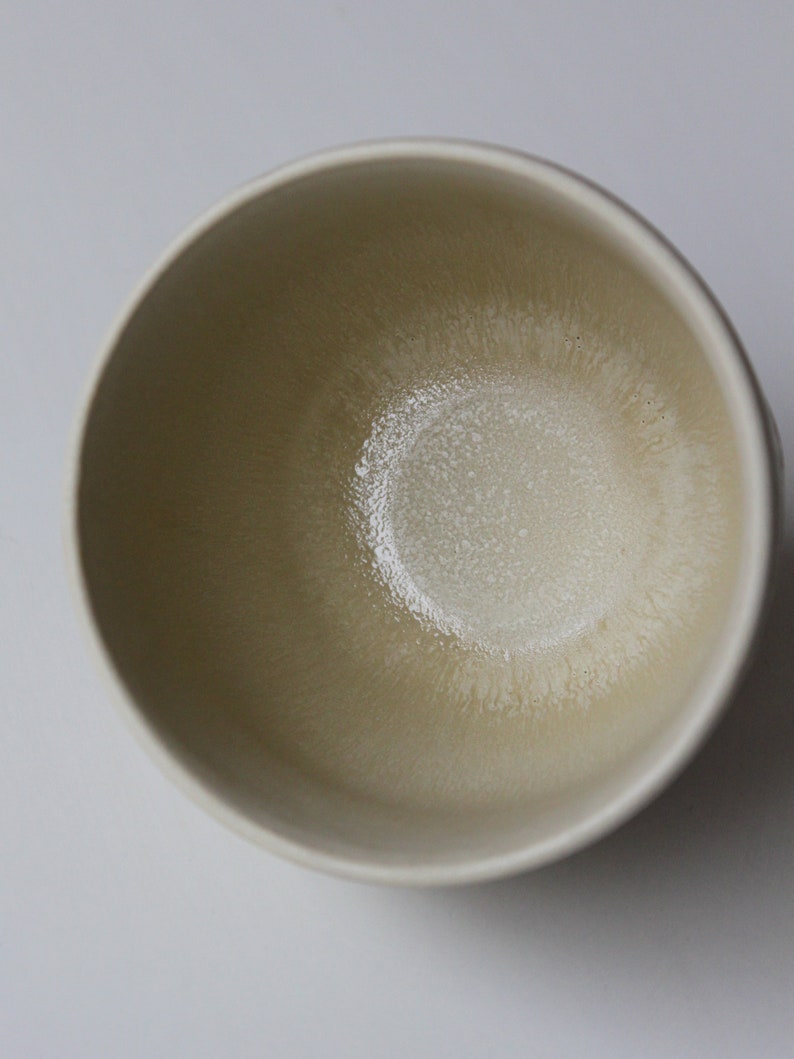 May include: A white ceramic bowl with a textured, slightly off-white interior.