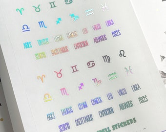 May include: A sheet of pastel coloured zodiac sign stickers. The stickers feature the astrological symbols and names for each sign. The sheet includes the signs Aries, Taurus, Gemini, Cancer, Leo, Virgo, Libra, Scorpio, Sagittarius, Capricorn, Aquarius, and Pisces.