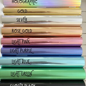 May include: A selection of colorful rolls of foil, each labeled with a different color and finish. Colors include holographic, gold, silver, rose gold, light pink, light purple, light blue, light green, and glossy black. The text is in a handwritten style.