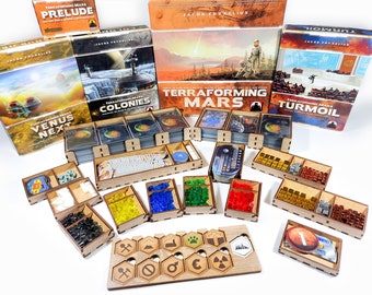 May include: A set of wooden game organisers for the Terraforming Mars board game. The organisers are filled with game components, including cards, tokens, and cubes. The game boxes are visible in the background, including the base game, the Venus Next expansion, the Colonies expansion, and the Turmoil expansion.