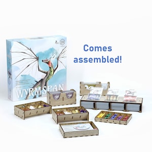 May include: Wooden organizer for the board game Wyrmspan. The organizer includes multiple compartments for cards, tokens, and other game components. The organizer comes assembled and is ready to use.