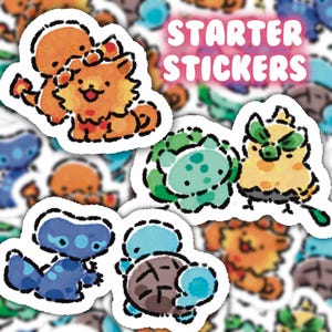 May include: A selection of cartoon stickers with a white border, featuring various creatures in shades of orange, blue, green, and yellow. The stickers include the text "STARTER STICKERS" in pink. The stickers are designed in a cartoon style.