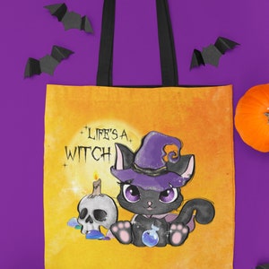 May include: A yellow canvas tote bag with black straps featuring a black cat wearing a purple witch hat and holding a potion bottle. The text "Life's a Witch" is printed on the bag.
