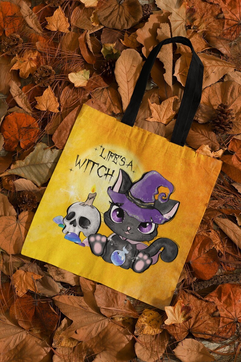 May include: A yellow tote bag with a black cat wearing a purple witch hat and holding a potion bottle. The text "Life's a Witch" is printed on the bag.