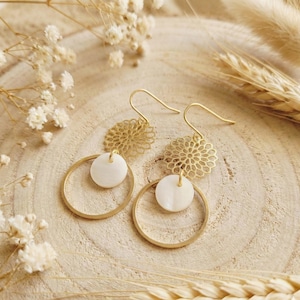 Geometric gold drop earrings with a circle, hoop design, and a flower and mother-of-pearl accent. Women's jewelry. Christmas jewelry gift.