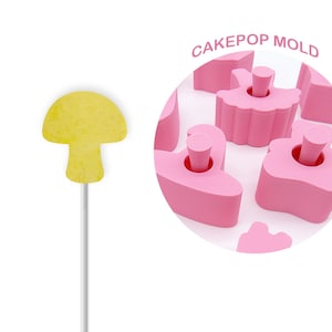 Peut inclure: Moule à cake pops rose avec différentes formes, dont un champignon, un cygne et un cœur. Le texte "CAKEPOP MOLD" est imprimé sur le moule.