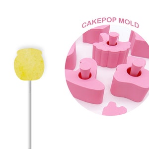 May include: Pink cake pop mold with a variety of shapes, including a ballerina, a heart, and a star. The mold is made of silicone and is designed to create cake pops that are easy to remove. CAKEPOP MOLD is written in white text on a pink circle.